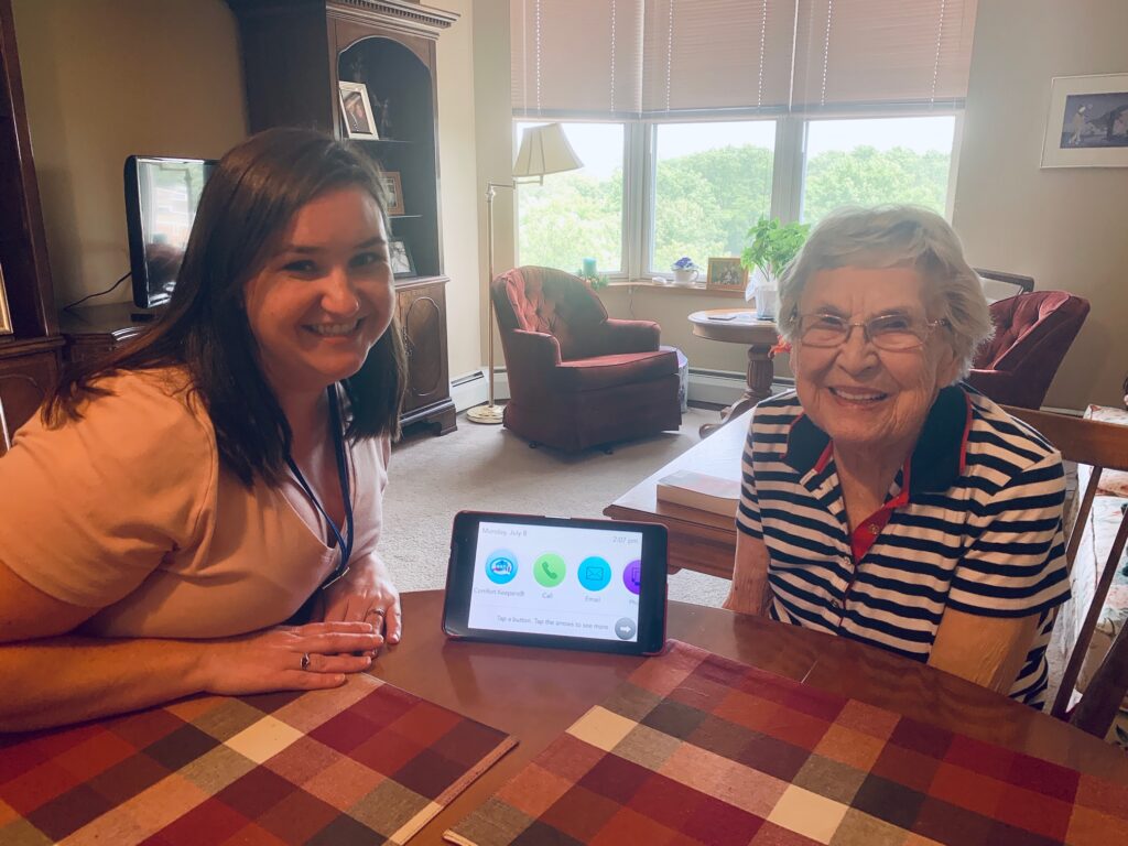 Image of a RosePointe Senior Living resident learning how to use the GrandPad to video chat